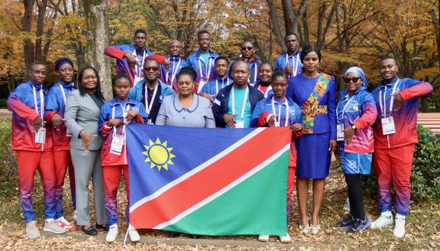 TOKYO, 19  November 2025 - Deputy Head of Mission at the Embassy of Namibia in Japan, Rebecca Iyambo (centre) poses for a photo with Namibia's deaflympians and technical members and coaches as well as employees of the Namibian embassy in Japan at the Komazawa Olympic Park General Sports Ground Athletic Field training ground. (photo by: Hesron Kapanga) NAMPA 