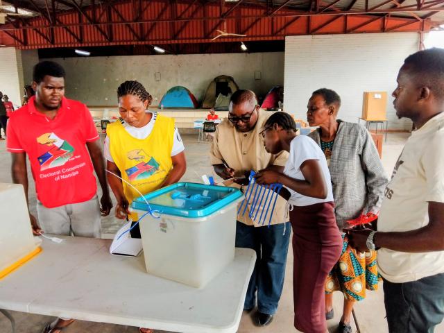KATIMA MULILO, 24 November 2025 - Katima Mulilo Urban Constituency Presiding Officer, Lilian Kachana (second from left), and other polling officials with political party agents affixing seals to the ballot boxes before the start of the 2025 Regional Councils and Local Authorities Elections at the Ngweze community hall on Monday.

(Photo: Michael Mutonga Liswaniso) NAMPA