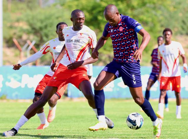 WINDHOEK, 13 December 2025 - The University of Namibia (UNAM) Football Club player Nestor Iyambo (in white) and African Stars defencer, Charles Hambira while in action during Round 12 of the Namibia Premier Football League at the UNAM Stadium. The game ended 1-1 extending UNAM's unbeaten run to 12 matches during the 2025/26 Premier League  Season. (Photo by: Hesron Kapanga) NAMPA