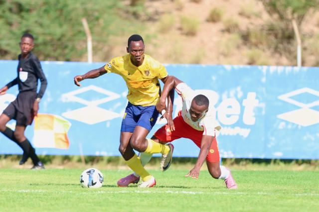 WINDHOEK, 31 January 2026 - Otjiwarongo-based Namibia Premier Football League (NPFL) outfit Mighty Gunners striker Mashiku Muyeka (in gold and black) while in action against Ronald Kauvi of UNAM FC during round 14 of the 2025/26 season at the UNAM Stadium. Mighty Gunners handed UNAM their first defeat after going unbeaten in 13 league matches. (Photo by: Hesron Kapanga) NAMPA
