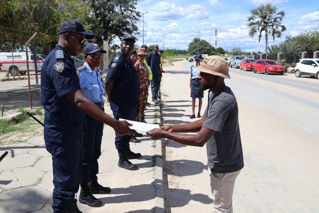 GROOTFONTEIN, 27 February 2026 - Teacher of Kalenga Primary School, Undjenu Mendez  (R) hands over a petition to police station commander of Omulunga in Grootfontein, Inspector Elifas Theophilus (L) shortly after teachers, learners and community members on Friday afternoon marched the streets against the rape incident of a 14-year-old Grade 5 girl of Kalenga Primary School who was raped on 19 February 2026 while on her way back home from school. (Photo by: Mulisa Simiyasa) NAMPA