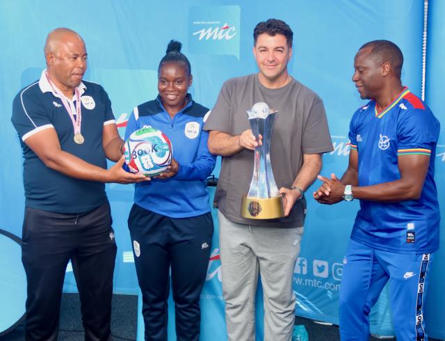 05 March 2026 - The senior national women’s football team, the Brave Gladiators, poses for a photo with MTC MTC’s Chief Brand, Marketing, Communications and Sustainability Officer, Tim Ekandjo (seated in blue) and Deputy Minister of Education Inovation, Youth, Sport, Arts  and Culture, Dino Balloti (second from right) and coach Lucky Kakuva and Lovisa Mulunga (second from left). The team received N.dollars 300,000 following their historic triumph at the Hollywoodbets COSAFA Women's Championship that was played in South Africa. (Photo by: Hesron Kapanga) NAMPA