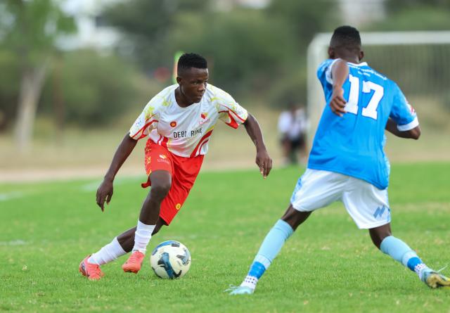 WINDHOEK, 14 March 2026 - UNAM FC right back, Simon Siririka (white and red) while in action against KK Palace players, Fillipus Abraham (right) at the UNAM Stadium during round 25 of the Namibia Premier Football League. The match ended 2-1 in favour of UNAM. (Photo by: Hesron Kapanga) NAMPA