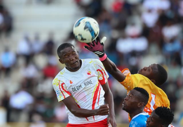 WINDHOEK, 14 March 2026 - A battle for the ball between KK Palace goalkeeper Landro Mundingi (right) and a UNAM player at the UNAM Stadium during round 25 of the Namibia Premier Football League. The match ended 2-1 in favour of UNAM. (Photo by: Hesron Kapanga) NAMPA