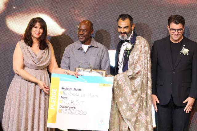 WINDHOEK, 28 March 2026 - Deputy Minister of Education, Innovation, Youth, Sport, Arts, and Culture, Dino Balloti (right) and Professor Dr Bavesh Kana hand over an award to a nominee at the National Research Excellence Awards. (Photo by: Ali Negumbo) NAMPA 