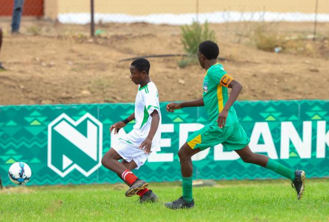 KEETMANSHOOP, 03 April 2026 - Action between a Kavango East player and(in white) and an Omaheke player in (green) during the 24th edition of the Nedbank Namibian Newspaper Cup at the West dene Stadium in Keetmanshoop. The opening match between the two sides in Group A, ended 1-1. (Photo by: Hesron Kapanga) NAMPA 