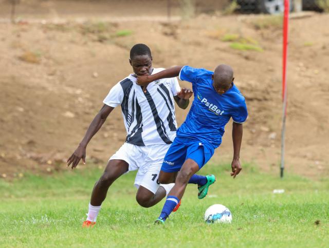 KEETMANSHOP, 03 March 2026 - Festus Natangwe of Oshikoto (in black and white) while in action against Likius Shikongo (in blue) of Ohangwena during their opening match of the 2026 Nedbank Namibian Newspaper Cup at the Westdene Stadium in Keetmanshoop. The match ended 4-1 in favour of Ohikoto. (Photo by: Hesron Kapanga) NAMPA