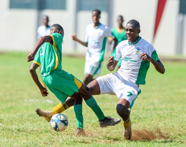 KEETMANSHOOP, 05 April 2026 - Omaheke defender McHenry Muundjua (in green) while fighting for the ball against Omusati's striker Peter Benyamen (in white) during the quarterfinal clash at the 2026 edition of the Nedbank Namibian Newspaper Cup at the Westdene Stadium in Keetmanshoop. Omaheke won the encounter 1-0. (Photo by: Hesron Kapanga) NAMPA 