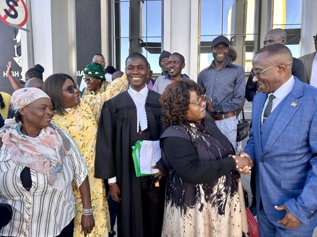 WINDHOEK, 16 April 2026- Lawyer Joas Neemwatya pictured with his clients outside the Windhoek high court. (Photo by Eba Kandovazu). NAMPA