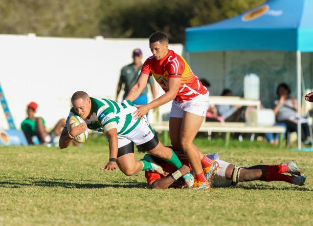 WINDHOEK, 09 May 2026 - UNAM Rugby Club player (in red and yellow) while in action against Western Suburbs during round four of the Namibia Rugby Union Premier League at the Western Suburbs Park in Khomasdal. UNAM won the match 28-07. (Photo by: Hesron Kapanga) NAMPA