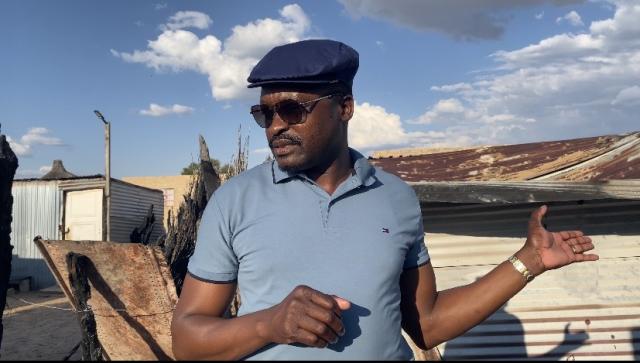 OMUTHIYA, 18 May 2026- Omuthiya constituency Councillor Erastus Nekomba standing behind the shack where two three-year-old girls perished in a fire.

(Photo: contributed)