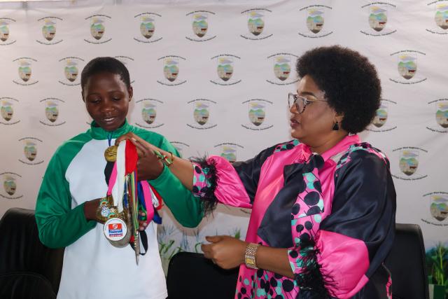 NKURENKURU, 12 June 2026- Kavango West Governor Verna Sinimbo with Maria Kanyanga (19) from Mukekete Village in Tondoro Constituency who is already a double Southern African champion. 

(Photo: Lylie Joel)
NAMPA