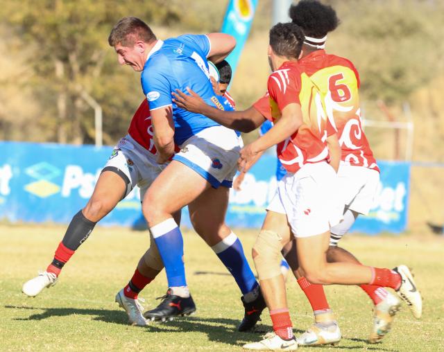 WINDHOEK, 20 June 2026 - Coastal outfit Kudus Rugby Club lock Sharon Rossouw in (blue with a ball) while in action against UNAM players Viery Haufiko (number six) at the UNAM Stadium on Saturday, during Round Six Namibia Rugby Union (NRU) Premier League clash the match ended 41-27 in favour of Kudus. (Photo by: Hesron Kapanga) NAMPA