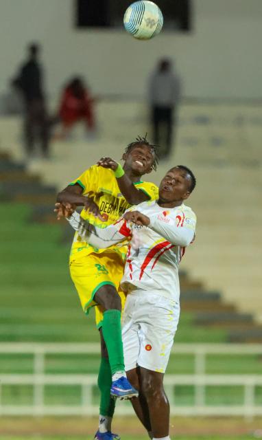 WINDHOEK, 20 June 2026 - Okahandja United player in (yellow and green) while in action against UNAM FC player in (white) at the Independence Stadium during the semi-final clash of the Namibia Football Association Cup. UNAM FC won the match 1-0. (Photo by: Hesron Kapanga) NAMPA