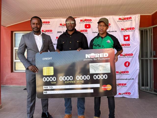 OPUWO, 23 June 2026 - NORED Chief Executive Officer Silverster Wayitti, Opuwo Town Council Councillor Victor Simon, and Kunene Regional Football Association executive committee member Sibona Amamub during the handover of a N.dollars 10 000 donation to the Kunene Under-20 football team in Opuwo on Monday. (Photo by: Kaviveterue Virere) NAMPA