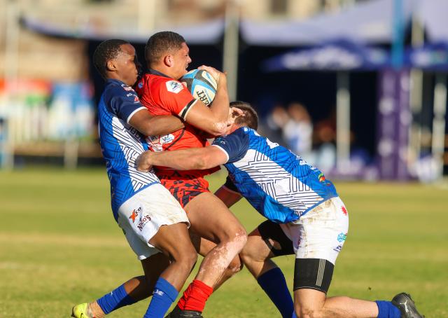 WINDHOEK, 18 July 2026 - Rehoboth rugby club players (in red) while in action against Trustco United (in blue) during round eight of the Namibia Rugby Union Premier League at the Trustco United field in Olympia. (Photo by: Hesron Kapanga) NAMPA