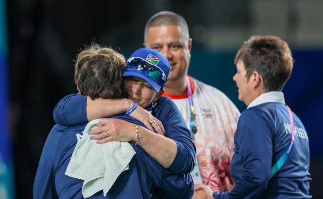 GLASGOW, 26 July 2026 – From left to right Namibia’s lawn bowls team has Amanda Steenkamp and Diana Viljoen and their coach embrasing themselves after completing their final  Section B match of the women’s pairs, at the Glasgow 2026 Commonwealth Centre. (Photo: Hesron Kapanga) NAMPA