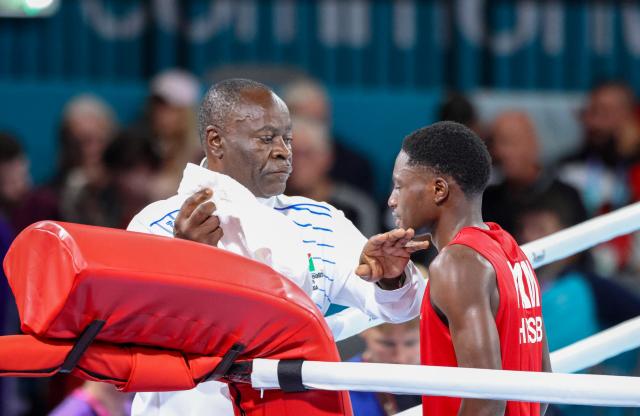 GLASGOW, 26 July 2026 - Coach Albertus Tamaseb inspecting Philip Pumulo Mutakela Haoseb (in red) ahead of his fight against Charif Yaya of Togo during Round of 16 bouts at the Commonwealth Games in Glasgow, Scotland. Haoseb secured victory with a second-round knockout to advance to the quarter-finals. (Photo: Hesron Kapanga) NAMPA
