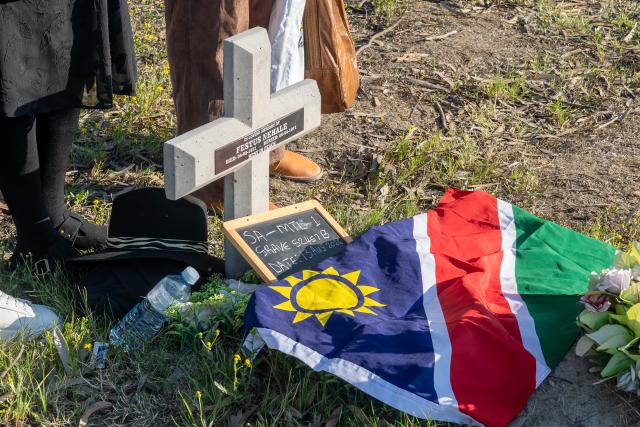 CAPE TOWN, 13 August 2026- A headstone bearing the name of Festus Nehale (died 04 March 1971) sits alongside a chalkboard marker reading "SA-MTL 1 GRAVE 52457 B DATE: 13 AUG 2026" and a draped Namibian national flag during the exhumation process in Cape Town, South Africa, on Thursday, 13 August 2026. (Photo Contributed: MICT)  NAMPA