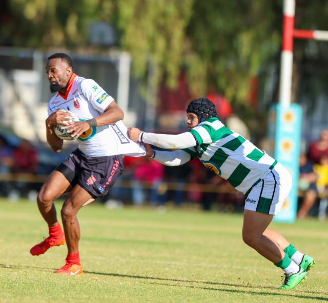 WINDHOEK, 15 August 2026 - Wanderers flyhalf Nandivatu Karuuombe (with a ball in white) while in action against Western Suburbs centre Jonathan Kamfer during Round 11 of the Namibia Rugby Union Premier League at the Wanderers Sports Ground in Pionerspark. Wanderers won the match 104-18. (Photo by: Hesron Kapanga) NAMPA 