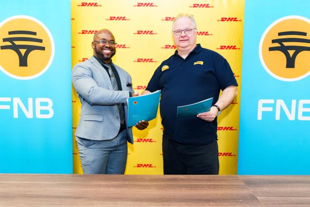 WINDHOEK, 21 October 2026 - FLTR Nesdha De Jongh, Head of SME at FNB Namibia shaking hands at the MoU signing ceremony with Dirk S. van Doorn, Managing Director of DHL Namibia. (Photo: Contributed) 