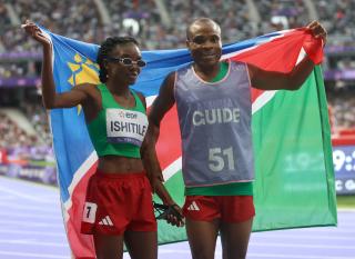 PARIS, 07 September 2024 – Paralympic sprinter Lahja Ishitile and her guide Sem Shimanda celebrating after winning Namibia’s second medal at the Paris 2024 Paralympic Games after finishing third in the women’s T11 200 metre (m) race at the Stade de Paris. (Photo by: Hesron Kapanga) NAMPA