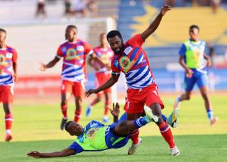 WINDHOEK, 19 October 2024 - Eeshoke Chula-Chula player Mwanyekange Matheus (in lime green) and Ibroihim Youssouf (in red and white) while in action during the Dr Hage Geingob Cup Cup final at the Independence Stadium. (Photo by: Hesron Kapanga) NAMPA