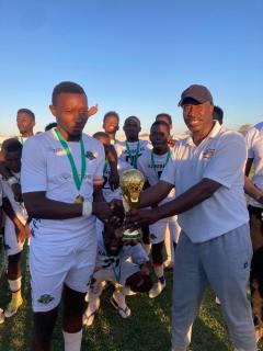 KARIBIB, 27 October 2024 - Top Score Mayoral Cup organiser Elvin Majiedt (right) presenting the trophy to Karibib FC captain during the final phase of the Top Score tourney that saw the Karibib-based outfit reigning supreme. (Photo: Contributed)