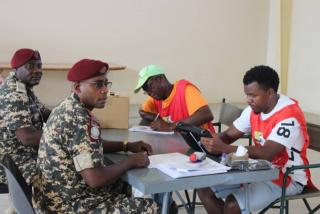 RUNDU, 13 November 2024 - Polling officials inside the Rundu Town Hall polling station helping uniformed members to cast their votes. (Photo by: Sawi Hausiku) NAMPA 