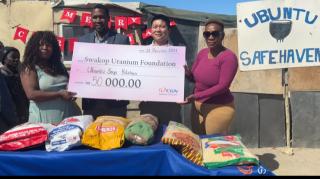 SWAKOPMUND, 23 December 2024 - (l to r) Jacky Garoes, owner of the Ubuntu Safe Haven Soup kitchen, Patrick Chizabulyo,Vice President Human Resorces and OOC at Swakop Uranium,  Swakop Uranium Head of Department and OOC Gao Rongbin and  Ellen Goses, Volunteer at Ubuntu Safe Haven soup kitchen during a donation handover of food parcels valued at N.dollars 50 000. (Photo by: Isabel Bento) NAMPA