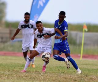 OSHAKATI, 02 January 2025 - Bucs Buccaneers' Giovanni Engelbrecht (left, in white) in action against KK Palace during the quarter-finals of the MTC Maris Cup at the Oshakati Independence Stadium. (Photo by: Hesron Kapanga) NAMPA