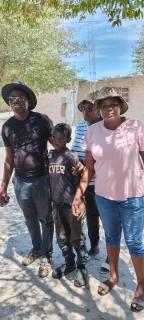 ONANKE, 28 February 2025 - Twelve-year-old Salom Samuel Shangula survived five days in the Etosha National Park by drinking rainwater and sleeping beneath the trees. He is pictured here with MEFT and NamPol officials. (Photo: Contributed)