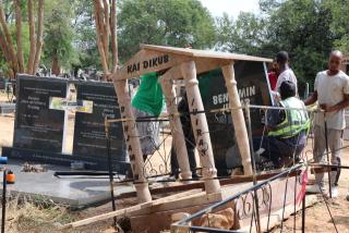 WINDHOEK, 24 March 2025- Family members fixing a gravesite and tombstone at the Gammams Cemetery. Several graves were damaged by the heavy rainfall experienced in the capital over the past few days. 
(Photo by: Linea Dishena) NAMPA 