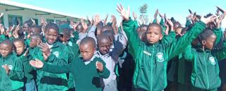 MARIENTAL, 12 MAY (NAMPA) - Learners of the Aimablaagte Primary School celebrate the planting of trees at their school in remembrance of the late Founding President, Dr. Sam Nujoma on Monday. Hardap Governor, Riaan McNab distributed 30 seedlings to local schools in Mariental on Monday.
( Photo by: Charmaine Boois) NAMPA