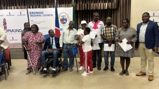 SWAKOPMUND, 16 May 2025 - Edith Kukuri (in red), the Chairperson of the National Federation of People with Disabilities in Erongo Region, photographed with five Swakopmund residents with disabilities who received plots from the Swakopmund constituency office on Friday. (Photo by: Isabel Bento) NAMPA