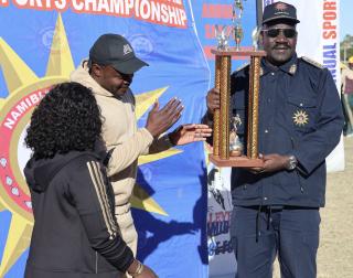 OTJIWARONGO, 28 June 2025 - Members of the Namibian Police Force (NamPol) from the Oshana Region at the 28th NamPol championship games at Otjiwarongo receives a trophy from the NamPol Inspector-General, Lieutenant-General Joseph Shikongo (R) on Saturday afternoon.  (Photo by: Mulisa Simiyasa) NAMPA