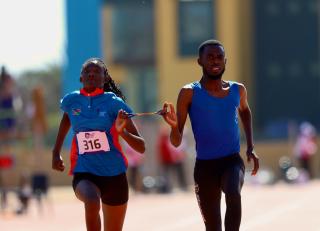 SWAKOPMUND, 09 July 2025 - T12 female sprinter, Ndapewa iipinge and guide Filipus Kotokeni while in action dureing the final of the 100 metres race and the Veneta Stadium during the African Union Sport Council (AUSC) Region Five Youth Games in Swakopmund. (Photo by: Hesron Kapanga) NAMPA