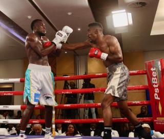 WINDHOEK, 08 November 2025 - Namibia’s super middleweight, Paulinus Ndjolonimus (in white and blue trunks), while in action against South Africa’s Snamiso Ntuli for the vacant World Boxing Organisation (WBO) Africa champions during the MTC Nestor Sunshine Tobias Boxing and Fitness Academy Boxing Bonanza, called “The Redemption Fight” at the Windhoek Country Club Resort. (Photo by: Hesron Kapanga) NAMPA