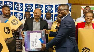 ONDANGWA, 21 November 2025- Sinomine Tsumeb Community Trust chairperson Max Johnson (C) handing over the information communication technology equipments donated the 14 schools offering advanced subsidiary level in Oshikoto region.

(Photo: Max Henrich) NAMPA