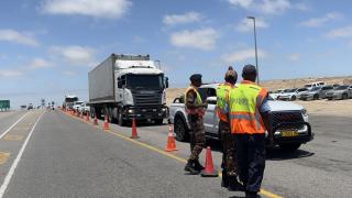 SWAKOPMUND, 09 December 2025 - Law enforcement officers intercepting vehicles at the Swakopmund roadblock as the regional road safety campaign kicks off. (Photo by: Isabel Bento) NAMPA