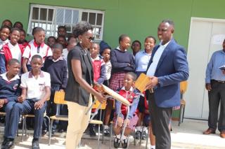 OSHAKATI,30 January 2026 - The Oshana regional governor Hofni Iipinge and  the school principal during the official handover of 50 school chairs to Ekuku primary school. (photo: Ester Hakaala) NAMPA