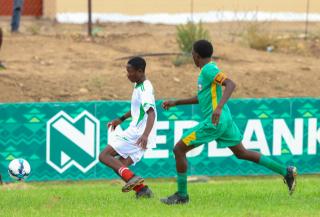 KEETMANSHOOP, 03 April 2026 - Action between a Kavango East player and(in white) and an Omaheke player in (green) during the 24th edition of the Nedbank Namibian Newspaper Cup at the West dene Stadium in Keetmanshoop. The opening match between the two sides in Group A, ended 1-1. (Photo by: Hesron Kapanga) NAMPA 