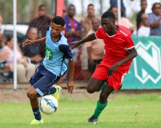 KEETMANSHOOP, 03 April 2026 - Action between Kavango West player Gideon Kayundu (in red) and ||Kharas player Johan Kooper during the 24th edition of the Nedbank Namibian Newspaper Cup at the Westdene Stadium in Keetmanshoop. The opening match between the two sides in Group B, ended 2-1 in favour of ||Kharas. (Photo by: Hesron Kapanga) NAMPA