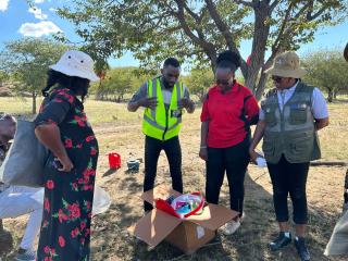 Otjimuhaka, 17 April 2026 – Phillip Likando, Personal Assistant to the Governor of Kunene Region, together with a health official and community members, during the distribution of donated mosquito nets, water sanitation supplies and other essential items to people affected by floods along the Kunene River at Otjimuhaka village (Swartbooi Drift). (Photo: Kaviveterue Virere) NAMPA 