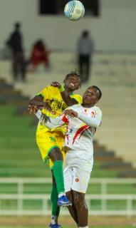 WINDHOEK, 20 June 2026 - Okahandja United player in (yellow and green) while in action against UNAM FC player in (white) at the Independence Stadium during the semi-final clash of the Namibia Football Association Cup. UNAM FC won the match 1-0. (Photo by: Hesron Kapanga) NAMPA