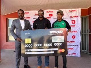 OPUWO, 23 June 2026 - NORED Chief Executive Officer Silverster Wayitti, Opuwo Town Council Councillor Victor Simon, and Kunene Regional Football Association executive committee member Sibona Amamub during the handover of a N.dollars 10 000 donation to the Kunene Under-20 football team in Opuwo on Monday. (Photo by: Kaviveterue Virere) NAMPA
