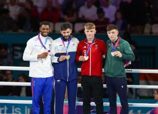 GLASGOW, 01 August  2026 – Namibia’s boxer Tryagain Morning Ndevelo pose with other boxers from left Sachin Sachin of India, Owain Harris-Allan of Wales, and Northern Ireland's Jude Gallagherhis during the medal award ceremony of the 60kg at the Commonwealth Games in Glasgow, Scotland. (Photo: Hesron Kapanga) NAMPA