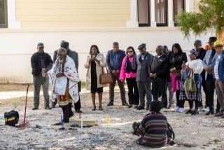 CAPE TOWN, 12 August 2026 – A Namibian traditional practitioner performs a spiritual cleansing ritual alongside members of the Namibian delegation in Cape Town. Cultural rites form a pivotal part of the exhumation process to honour the spirits of fallen liberation heroes Simon Petrus Niilenge, Festus Nehale, and their comrades before their repatriation back home. (Photo Contributed: MICT) NAMPA