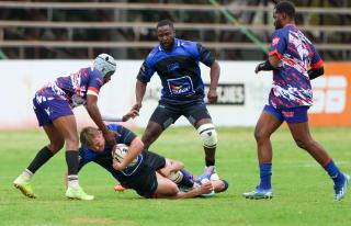 WINDHOEK, 12 September 2026 - Vipers and Keetmanshoop Rams Rugby Clubs players (in blue/dark blue and white, blue and red) while in action during the second semifinals of the Namibia Rugby Union (NRU) First Division championship trophy at the Hage Geingob Stadium. Oranjemund won the match 26-19 to qualify for the final against Vipers. (Photo by: Hesron Kapanga) NAMPA
