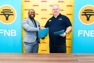 WINDHOEK, 21 October 2026 - FLTR Nesdha De Jongh, Head of SME at FNB Namibia shaking hands at the MoU signing ceremony with Dirk S. van Doorn, Managing Director of DHL Namibia. (Photo: Contributed) 